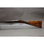 A BSA 12 bore side by side shotgun, with 28" sleeved barrels, improved and quarter choke,