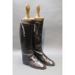 A pair of late 19th/early 20th century riding boots, with wooden shoe trees.