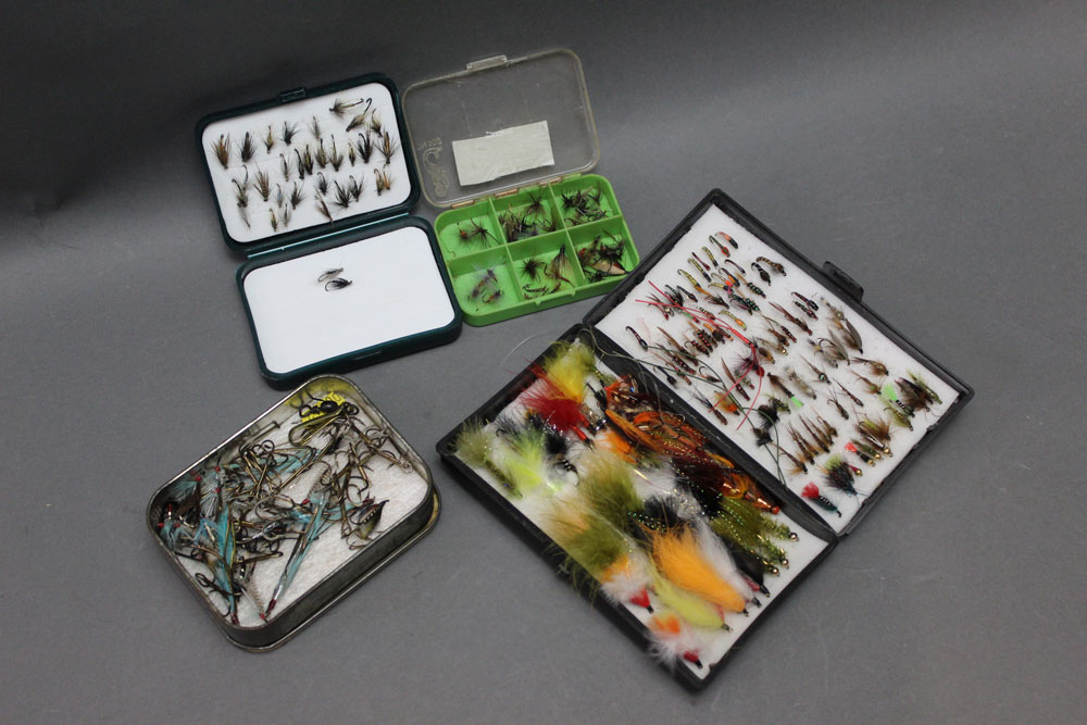 A House of Hardy plastic fly box, together with three others, containing trout and sea trout flies.