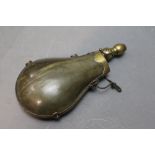 * A pressed horn bodied powder flask, with unusual folding brass nozzle, height when open 20 cm.