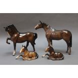 Four brown Beswick horses, to include model No. 1549 second version, two lying foals, model No.