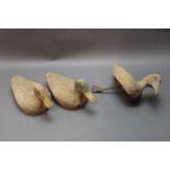 Four mid 20th century wooden duck decoys with folding brass keels,