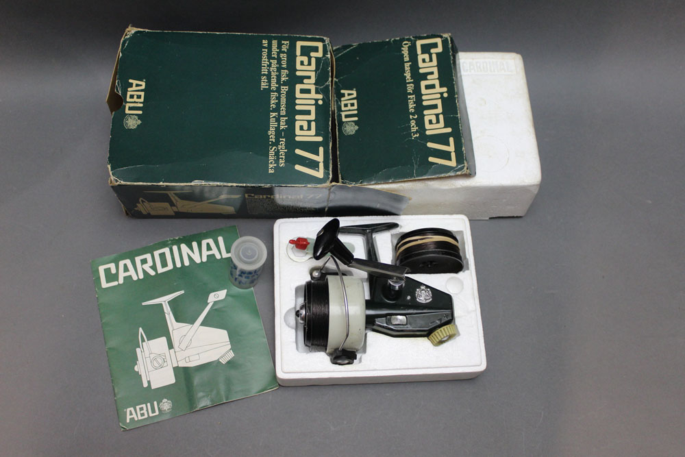 An Abu Cardinal 77 fixed spool reel, with original packaging.