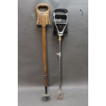 * Two shooting sticks, one wooden and marked with a crescent type letter C. Height 87 cm.