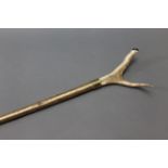A hazel shafted walking stick with metal collar and stag antler thumb section. Length 136 cm.