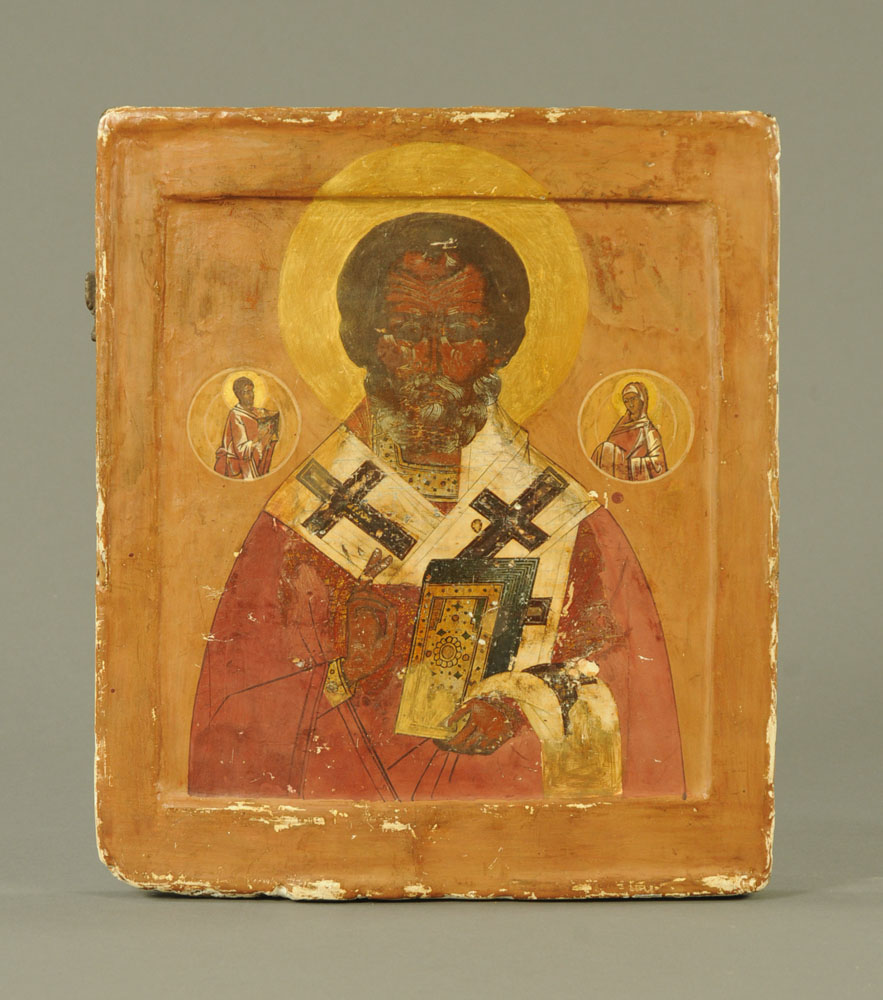 A Russian icon, painted on wood with central figure,