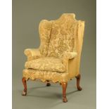 An 18th century wing back armchair,