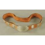 A Cumberland Wrestling Milnthorpe Championship 1910 belt, 11 1/2 stone category (see illustration).