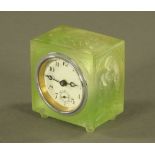 A 1930's green frosted relief moulded glass desk clock. Width 7 cm.