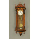 A late 19th century walnut Vienna regulator wall clock in the manner of Gustav Becker,