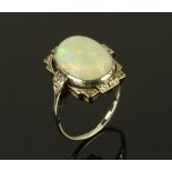 An 18 ct white gold opal and diamond set ring, Size R, opal dimensions +/- 14 mm x 11 mm.