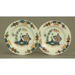 A pair of late 18th century tin glazed earthenware plates, decorated with flower heads.