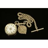 A late 19th century foliate engraved silver cased fob watch, with chain and silver fob.