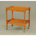 A 19th century mahogany two tier tea trolley, of traditional rectangular form,