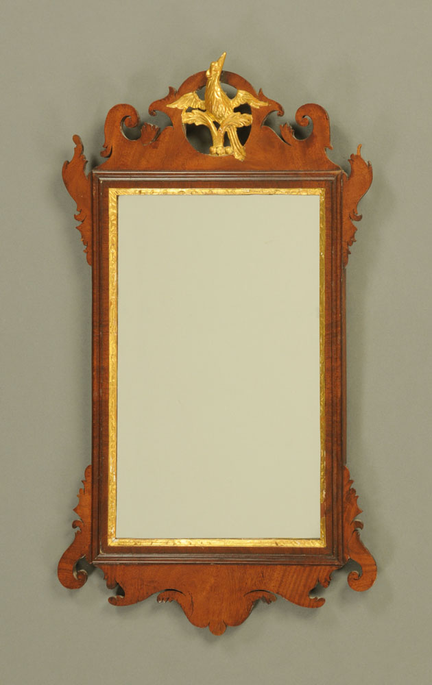 A Chippendale style fretwork wall mirror, with Ho Ho bird surmount. Height 71 cm, width 40 cm.