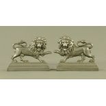 A pair of late Victorian pewter lion door porters. Each 18 cm high x 23 cm long.