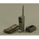 A vintage Motorola 8500X cell phone, with battery and charger etc.