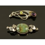 An Art Nouveau silver gem set brooch and another.