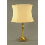 A 20th century brass table lamp, with shade. 73 cm overall.