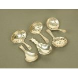 Five George III silver caddy spoons, all probably by George Burrows, four with pierced bowls,