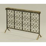 A Victorian design wrought iron fire screen, with pierced scrolled ornament, on splayed feet.