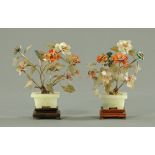 A pair of Chinese jade and hardstone models of trees, in square planters and on hardwood stands,