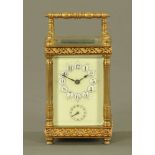 A brass carriage clock, timepiece with alarm, with Arabic numerals and subsidiary alarm dial.