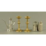 A pair of brass candlesticks of Gothic style, with shaped drip trays,