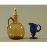 An early 19th century amber glass decanter, with silver plated mount,