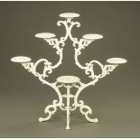 A white painted cast iron jardiniere stand. Height 108 cm, width 112 cm.