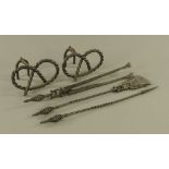 A set of three wrought iron fire implements, with spiralled handles and pierced decoration,