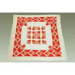 A Victorian quilt, red and white patterned. 220 cm x 208 cm.