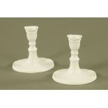 A pair of modern Italian white glazed porcelain candlesticks, of neo-classical shape, 15 cm high.