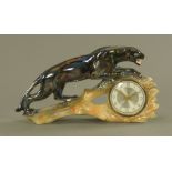 A Gema iridescent pottery cased mantle clock, of Art Deco design, modelled with a stalking jaguar.