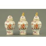 Three Samson armorial porcelain lidded vases, each decorated with floral sprays,