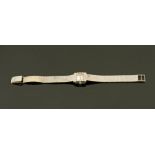 An 18 ct white gold cased and diamond set Omega ladies wristwatch, with bark effect strap,