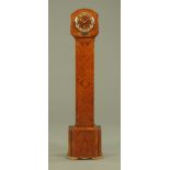 An Art Deco walnut cased grandmother clock, with three train striking movement with circular dial.