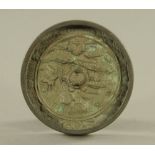 A bronze circular mirror, cast in relief with raised turtle, cranes and foliage, Hang dynasty style,
