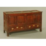 An 18th century panelled oak mule chest,