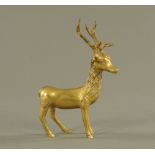 An eastern brass figure of a standing deer, 23 cm high.