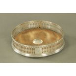 A George III silver wine coaster with fretted sides and cabochon boss to centre,