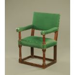 An oak open armchair of 18th century style, the back,