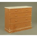 A Victorian white and brown painted chest of drawers, on plinth supports.