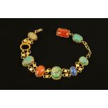 A gold coloured metal bracelet, with scarab beetle and hardstone links.