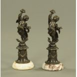 A pair of brown patinated bronze figures of Cupid,