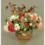 A bouquet of faux flowers in an Arts & Crafts painted terracotta jardiniere.