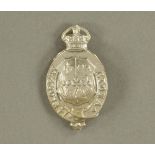 An Eton College Officers' pressed white metal cap badge, worded "Floreat Etona", 5.5 cm high.