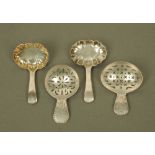 Four George III silver caddy spoons by Urquhart & Hart, displaying different styles and patterns,