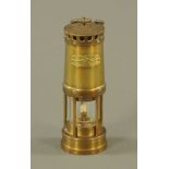 A vintage Welsh brass miners lamp, by E Thomas and Williams Ltd., 22 cm high.