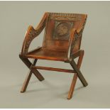 Victorian oak Glastonbury chair with carved crest and motto to the back with carved detail to the